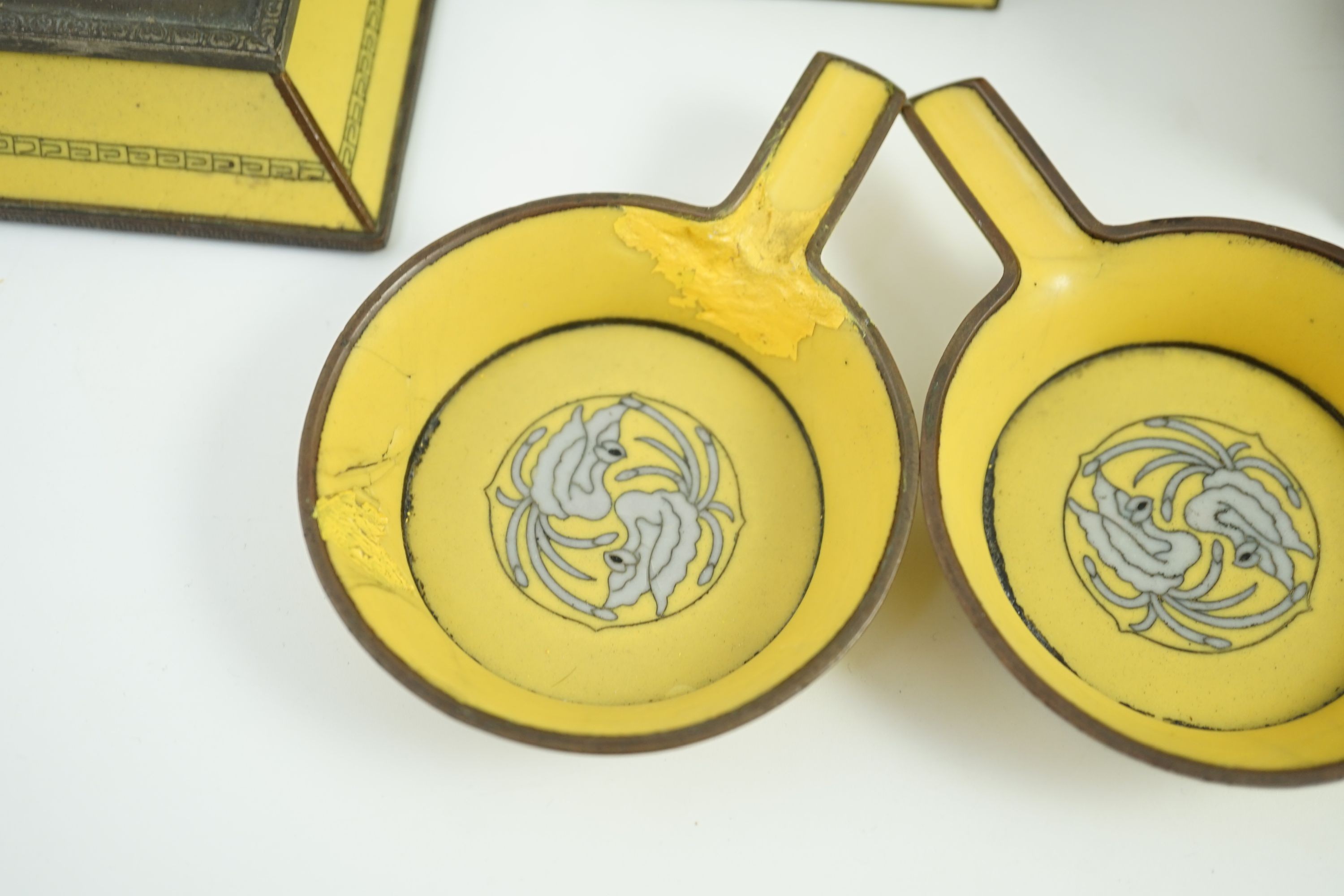 A Japanese cloisonné enamel desk set, 1920s, mounted with two Chinese Qing dynasty pale celadon jade plaques, retailed by Yamanaka & Co., Inkstand 31cm wide